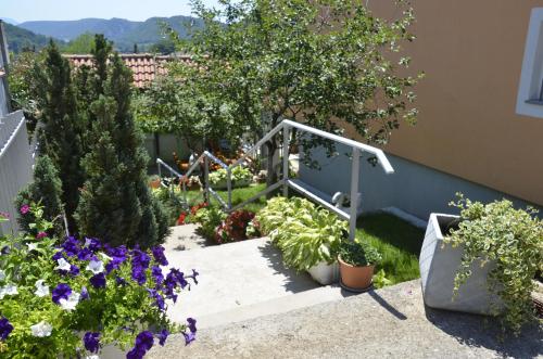 a garden with flowers and plants on the stairs at Apartments Lilly in Rijeka