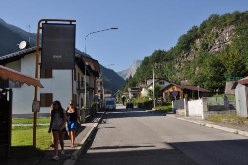 two women walking down a street in a village at Hotel Galles in Paluzza
