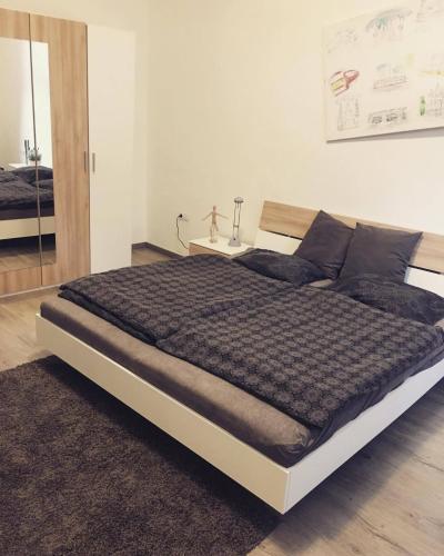 a bedroom with a large bed with aokedokedokedoked at Wonderful Apartment Budapest in Budapest