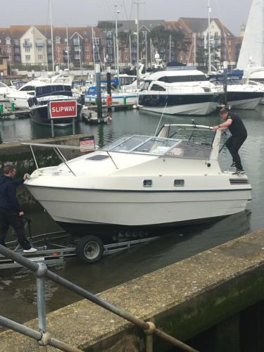a man is on a boat in a marina at The Ocean Guest House in Weymouth