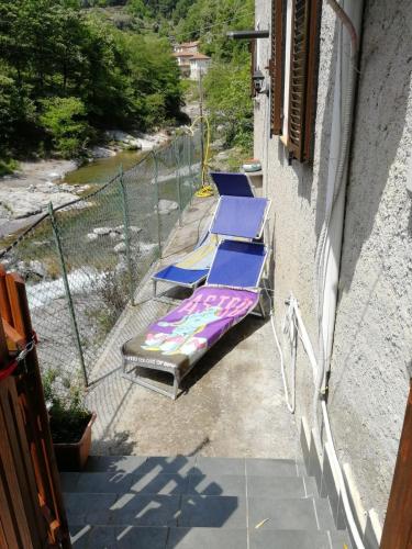 a couple of lounge chairs sitting on a balcony at The River House in Agaggio Inferiore
