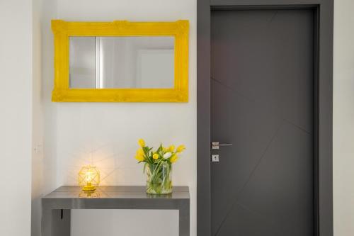 a black door with a vase of flowers on a table at GCF Luxury Suites, Guest house in Rome