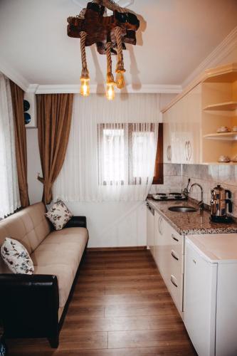 a living room with a couch and a kitchen at Ayder Palas Apart Hotel in Ayder Yaylasi