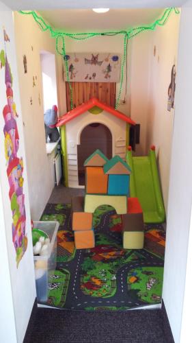 a play room with a toy dog house and a play set at Penzion U Elišky Bedřichov V Jizerských Horách in Bedřichov