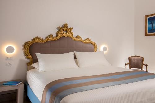 a bedroom with a large bed and a chair at GCF Luxury Suites, Guest house in Rome