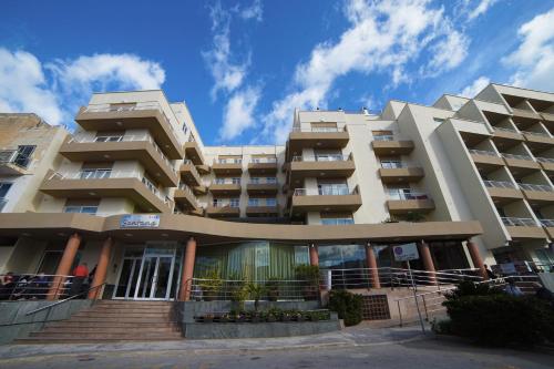 a large building with stairs in front of it at Hotel Santana in St Paul's Bay