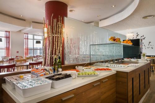 a buffet line in a restaurant with fruits and vegetables at Sure Hotel by Best Western Muenchen Hauptbahnhof in Munich
