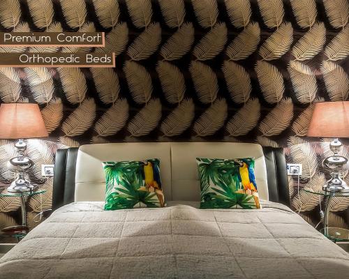 a bedroom with a large bed with two lamps at FaRoyal Luxury Suite in Eilat