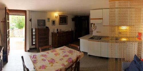 a kitchen with a table and a counter top at casa elba relax in Rio nellʼElba