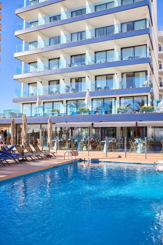 a hotel with a swimming pool in front of a building at Hotel Negresco - Adults Only in Playa de Palma