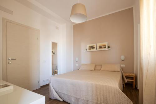 a bedroom with a white bed in a room at B&B Bellavista Gallipoli in Gallipoli