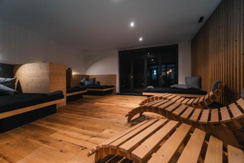 a room with benches and couches in a building at Anett hotel in Vipiteno