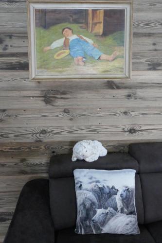 a painting on the wall of a living room with a couch at Châlet Birkhahn in Saas-Fee