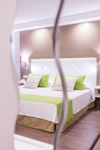a bedroom with two beds with green pillows at Hotel RF San Borondon in Puerto de la Cruz