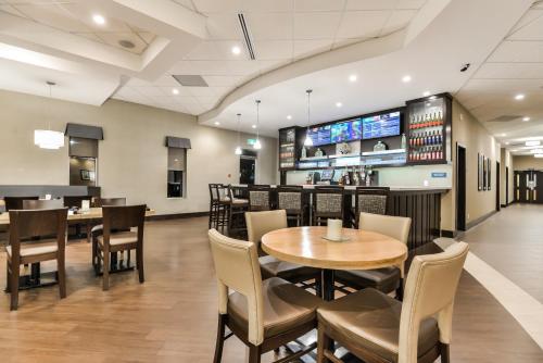 a restaurant with tables and chairs in it at Best Western Plus Leamington Hotel & Conference Centre in Leamington