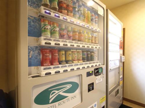 a refrigerator filled with bottles of soda at Hotel Route-Inn Nago in Nago
