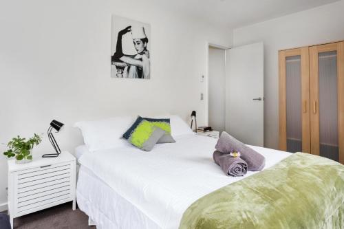 a bedroom with two beds and a night stand with a lamp at Melbourne Villa in Melbourne