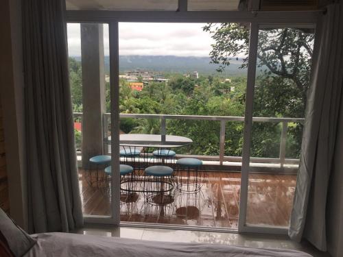 a view of a balcony with a table and chairs at Alta Residences in Daraga