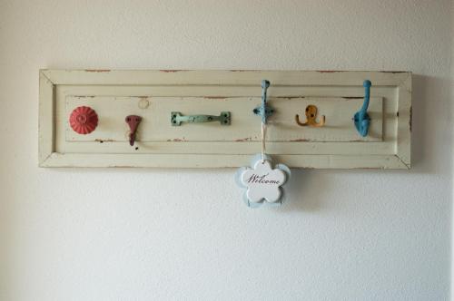 a shelf with a bunch of buttons on a wall at Nel verde del Villaggio - Casetta Celeste in Gonnesa