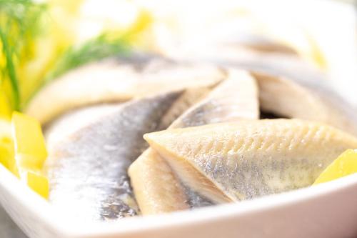 a plate of food with fish and vegetables at Michels Inselhotel Vier Jahreszeiten in Norderney