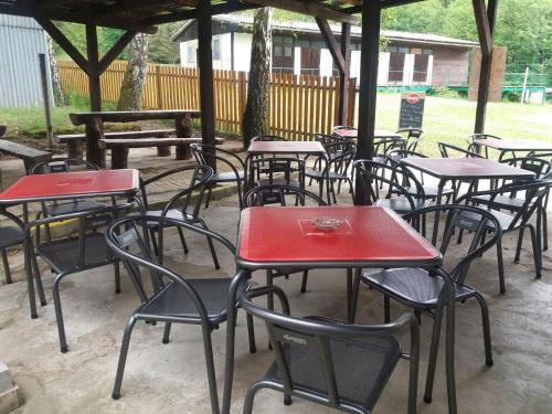 a group of tables and chairs sitting under a pavilion at Autocamp Slunce Žandov in Žandov