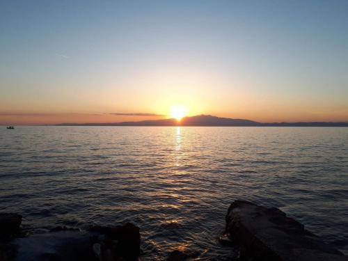 a sunset over a large body of water at Bluetopia studio in Skala Kallirachis