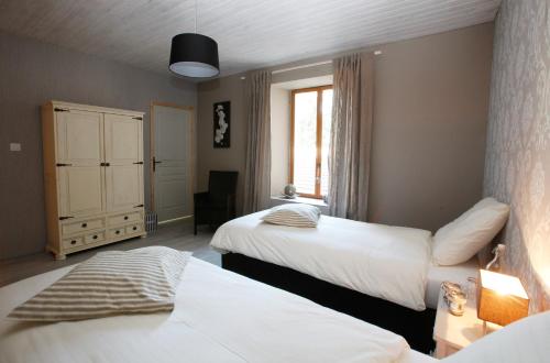 ein Hotelzimmer mit 2 Betten und einem Fenster in der Unterkunft Arara in Montfaucon-dʼArgonne
