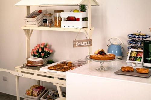 a bakery counter with pastries and other food items at B&B Casa di Anita in Arnesano