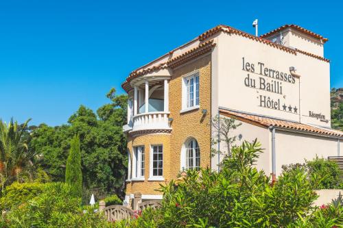 an old house with a sign on the side of it at Les Terrasses du Bailli in Rayol-Canadel-sur-Mer