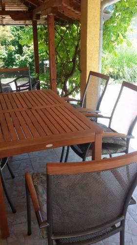 a wooden table and chairs on a patio at Apartment Holiday in Vrnjačka Banja