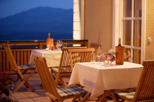 two tables and chairs with wine glasses on a patio at Winzerhaus Friedrich in Kaindorf