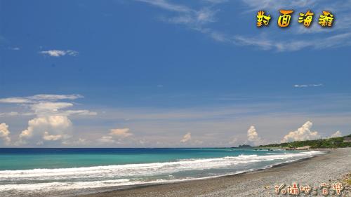 a view of a beach with chinese writing on it at Ez Bay Homestay in Chenggong