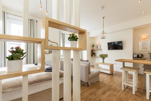 a living room with a couch and a table at Accudo House Boutique Holiday Suites in Portsmouth