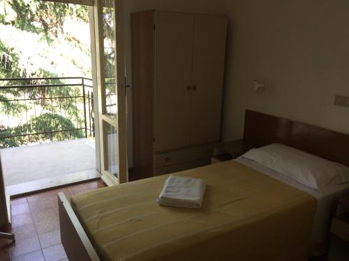 a bedroom with a bed with a towel on it at Hotel Belvedere in Castrocaro Terme