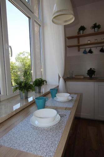a kitchen with two white plates on a table at Młyńska2 in Bielsko-Biała
