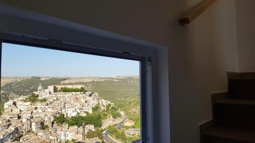 a window with a view of a city at Incanto barocco in Ragusa