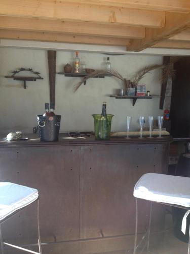 a kitchen with two chairs and a counter with glasses at Esprit d'Ailleurs in Baillargues