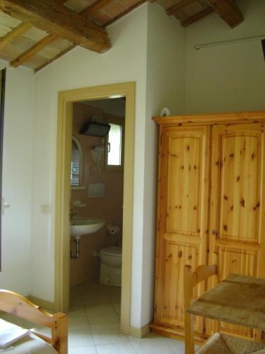 a bathroom with a sink and a toilet and a table at Fondo Riso in Faenza