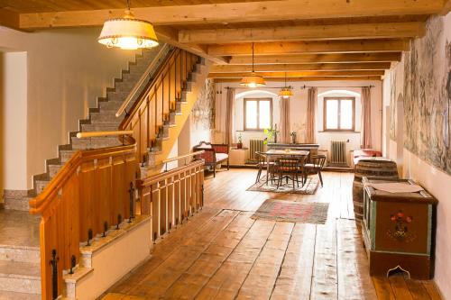 a large room with stairs and a table and chairs at Almerwirt in Maria Alm am Steinernen Meer