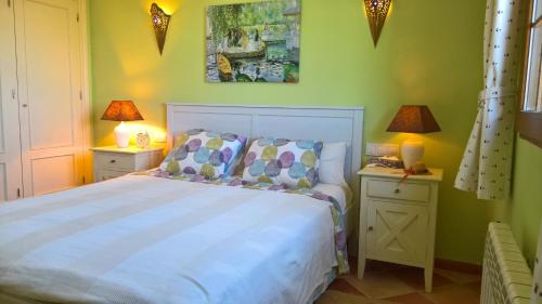 um quarto com uma cama e duas mesas de cabeceira com candeeiros em Calapanizo "Un paraíso" em El Pozo del Esparto