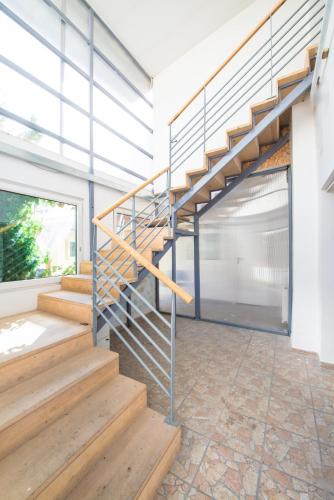 a metal staircase in a house with a garage at Chesscom Guesthouse in Budapest