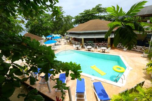 an overhead view of a swimming pool with blue lounge chairs at Merrils Beach Resort II in Negril
