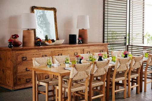a dining room with a table with chairs and a mirror at Hotel San Cristobal Adults 15+ in Todos Santos