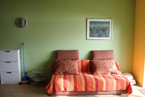 a bedroom with a bed and a clock on the wall at Primavera in Omišalj