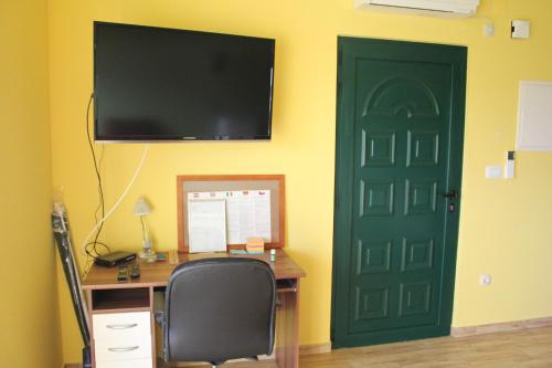 an office with a green door and a desk with a computer at Primavera in Omišalj