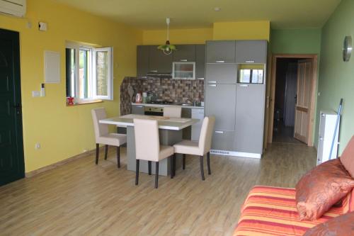 a kitchen and living room with a table and chairs at Primavera in Omišalj