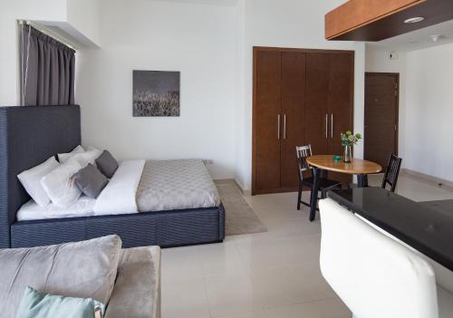 a bedroom with a bed and a table in a room at Frank Porter - West Wharf in Dubai