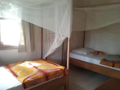 Postel nebo postele na pokoji v ubytování Jardin d'Afrique