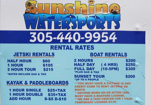 a poster for a water sports event with prices at Gilbert's Resort in Key Largo