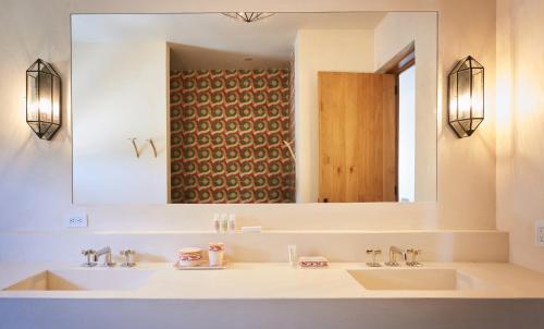 a bathroom with a sink and a mirror at Hotel San Cristobal Adults 15+ in Todos Santos